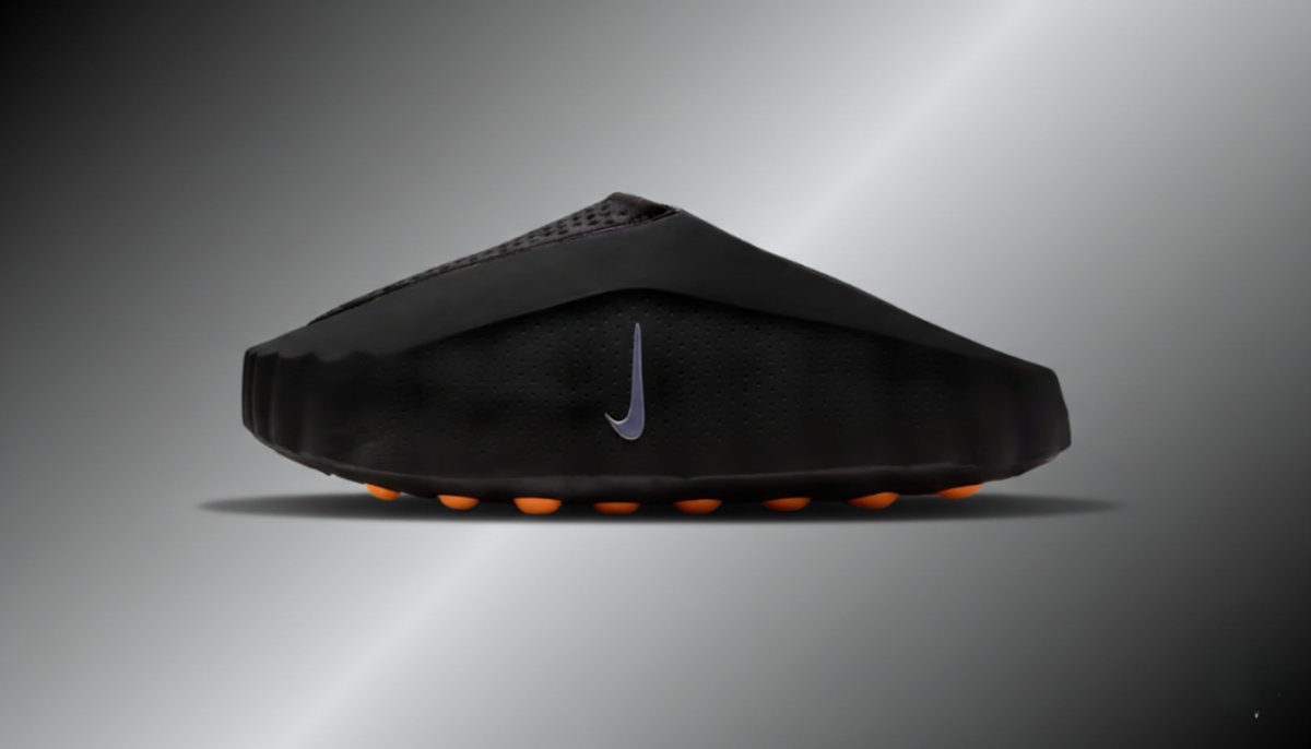 Black sandal with orange accents on a gray background